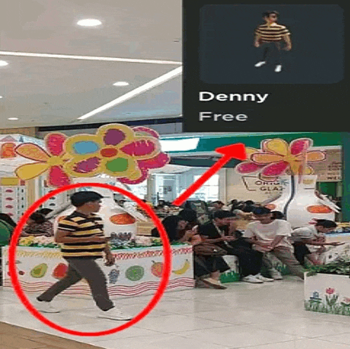 a man in a yellow and black striped shirt is walking in front of a sign that says denny free on it