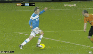 a soccer player in a blue jersey is kicking the ball