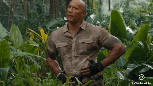 a man standing in a jungle with a regal logo on the bottom