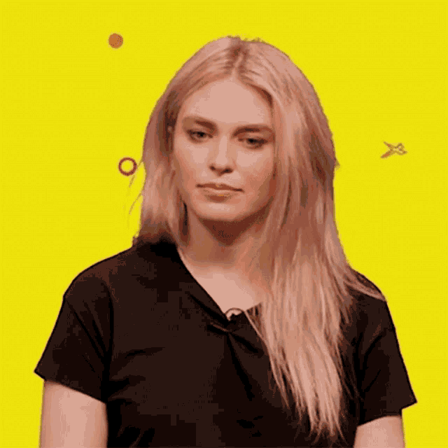 a woman in a black shirt is looking at the camera