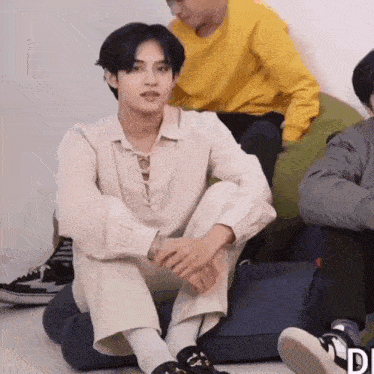 a man is sitting on a bean bag chair with his legs crossed