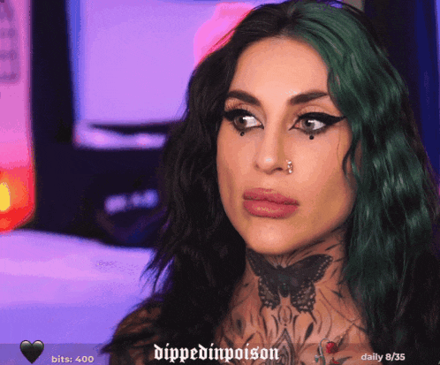a woman with green hair has a tattoo of a butterfly on her neck and the words dipped in poison on the bottom