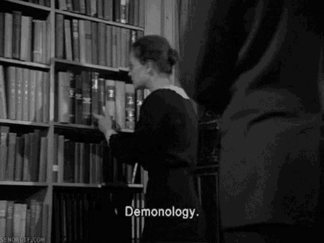 a black and white photo of a woman in a library with pornography written on the bottom right