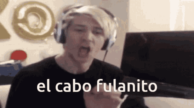a man wearing headphones says el cabo fulanito in front of a computer monitor