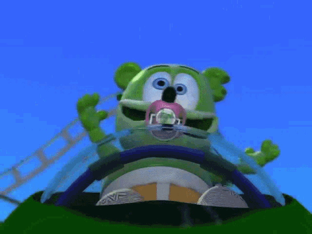 a gummy bear with a pacifier in its mouth is driving a car
