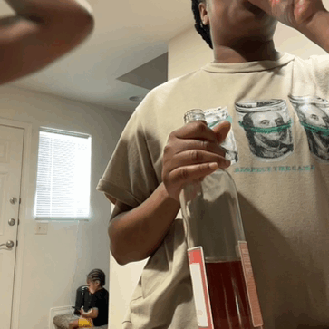 a man drinking from a bottle while wearing a t-shirt that says respect the case