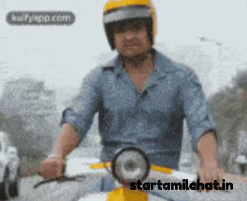 a man wearing a yellow helmet is riding a scooter with the website starttamilchat.in in the background