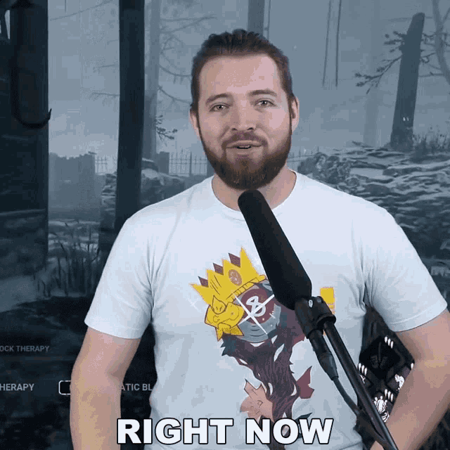 a man with a beard is standing in front of a microphone with the words right now above him