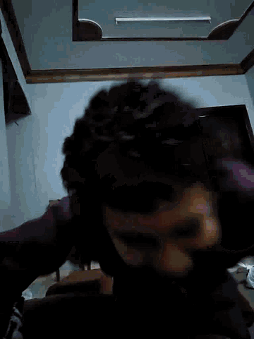 a blurry picture of a person 's face in a room