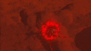 a video game character with red eyes is crawling in the dirt .