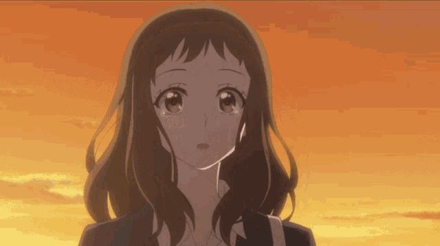 a close up of a girl 's face with tears in her eyes