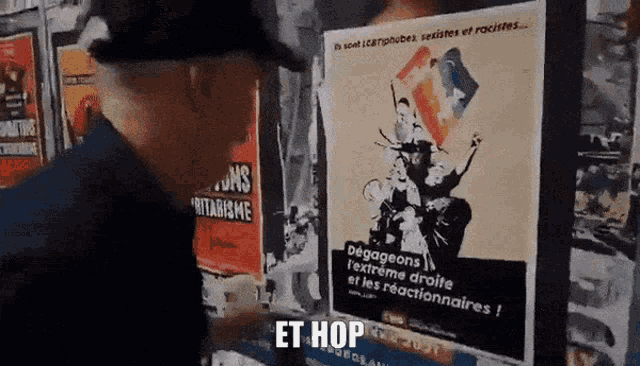a man is standing in front of a poster that says et hop