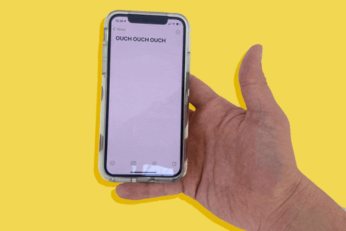 a person is holding a cell phone that says ouch ouch ouch