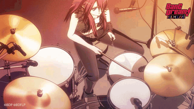 a girl is playing drums in front of a microphone with the words bang dream written on the bottom