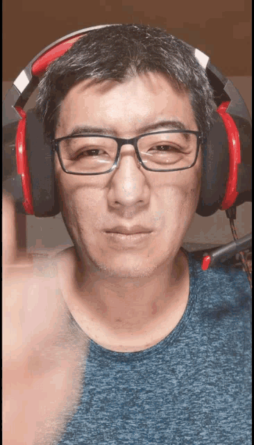 a man wearing glasses and headphones with a microphone