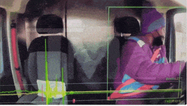 a woman in a purple jacket is sitting in a car with a green screen behind her that says twilight