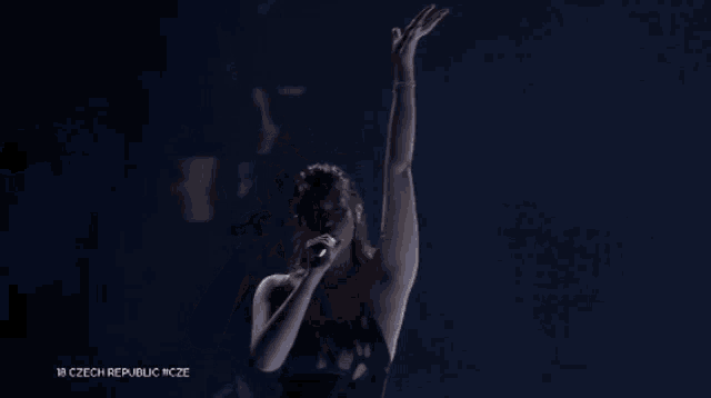 a woman singing into a microphone with the words 18 czech republic cz on the bottom