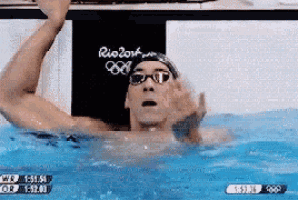 a man is swimming in a pool with the word rio on the back