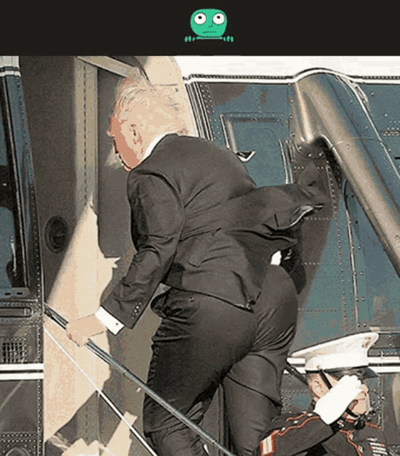 a man in a suit climbs the stairs of a helicopter
