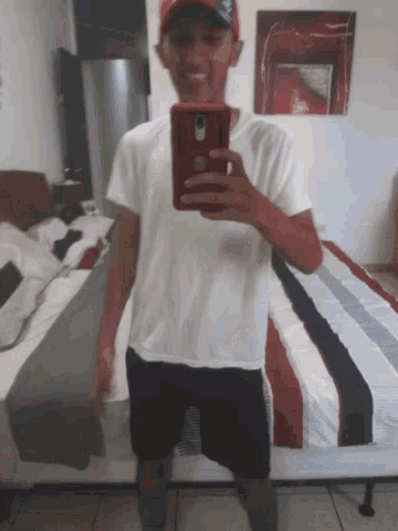 a man is taking a picture of himself with his phone