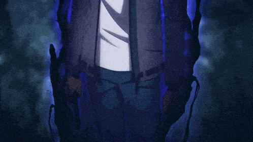 a man in a white shirt and gray jacket is standing in a dark room