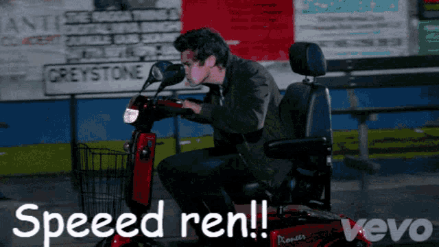 a man is riding a red scooter with the words speed ren on it