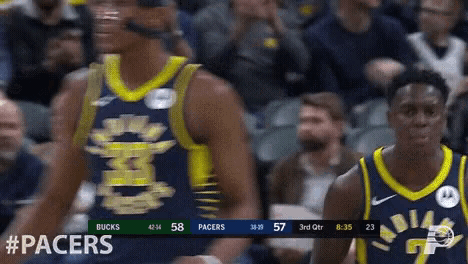 two indiana pacers players are standing in front of a crowd