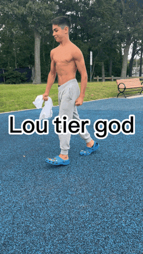 a shirtless young man is walking on a blue surface with the words lou tier god written above him