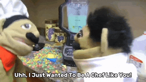 a chef puppet is talking to another puppet in front of a blender