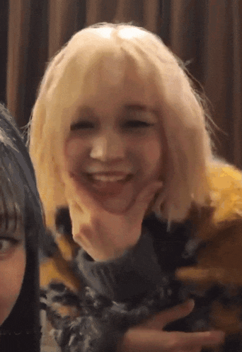 a woman with blonde hair is making a funny face