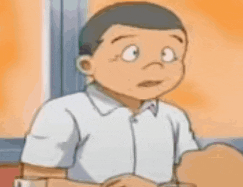 a cartoon boy with a surprised look on his face is sitting at a table with his hands folded .