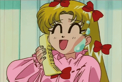 a girl in a pink dress is talking on a phone