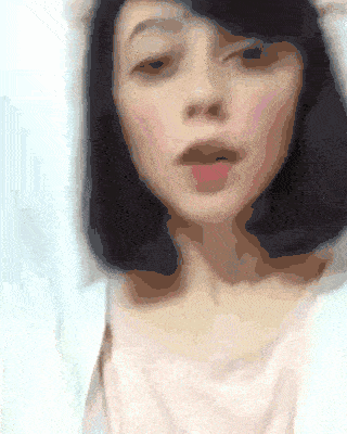a blurry picture of a woman 's face with a white background