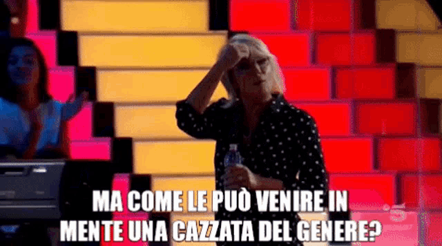 a woman stands in front of a brick wall and says ma come le puo venire in mente una cazata del genere