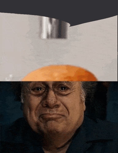 a close up of a man 's face with a hamburger on top of him