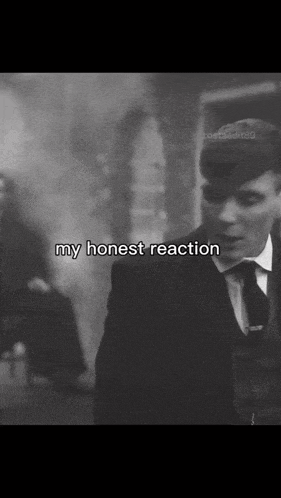 a black and white photo of a man in a suit and tie with the words my honest reaction