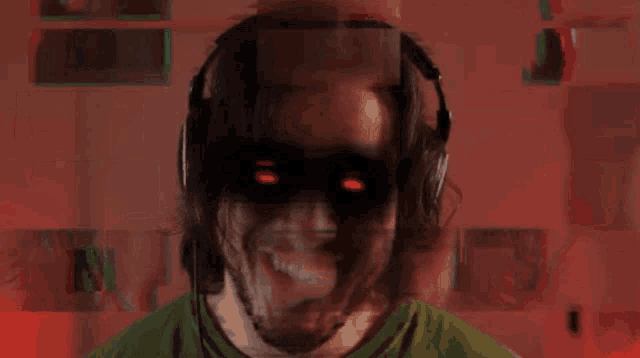 a man wearing headphones and a green shirt is smiling with red eyes