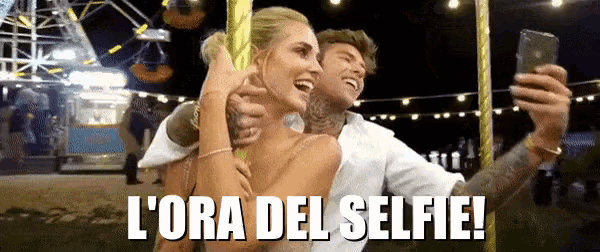 a man and a woman are taking a selfie with the words l' ora del selfie