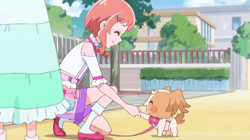 a girl kneeling down petting a dog on a leash