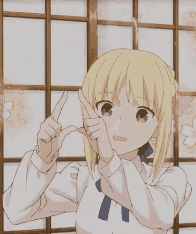 a blonde anime girl holds a piece of chocolate in her hands