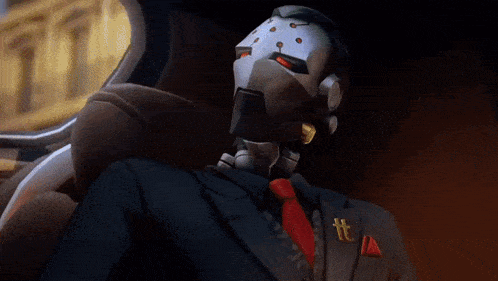 a robot in a suit and tie with a t on his pin