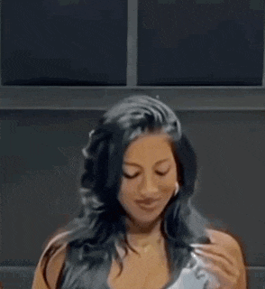 a woman with long black hair is holding a telephone in her hand .