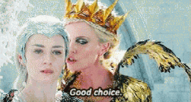 two women are standing next to each other and one is wearing a crown .