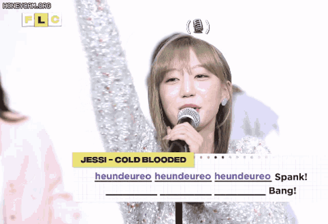a girl is singing into a microphone with the words jessi cold blooded written on the bottom