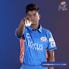 a man wearing a blue shirt with lotus on it