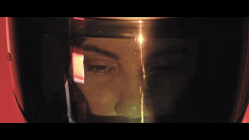 a close up of a woman 's face behind a glass