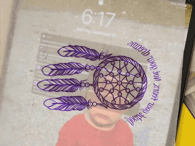a phone screen shows the time as 6:17 and a picture of a child