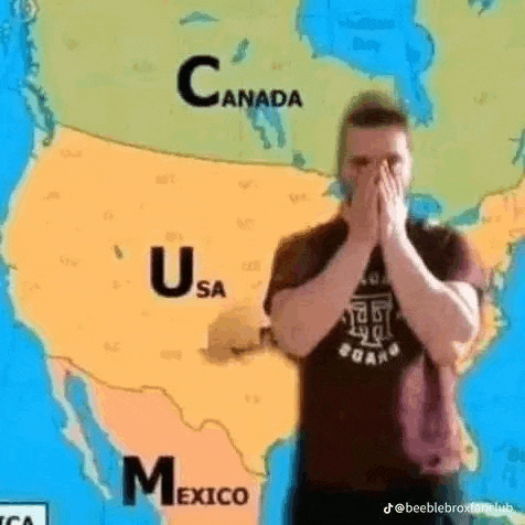 a man is standing in front of a map of the united states covering his face .