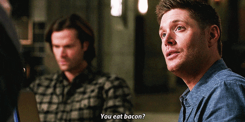 a man says " you eat bacon " while another man sits behind him