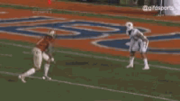 two football players are playing a game on a field . one of the players is wearing a number 1 jersey .